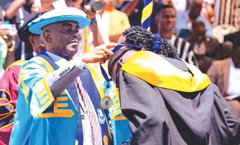 Dr Jethro W Brooks, Jr, acting Vice-Chancellor of the Regional Maritime University, decorating one of the graduands with a medal Dr Jethro W Brooks, Jr, acting Vice-Chancellor of the Regional Maritime University, decorating one of the graduands with a medal