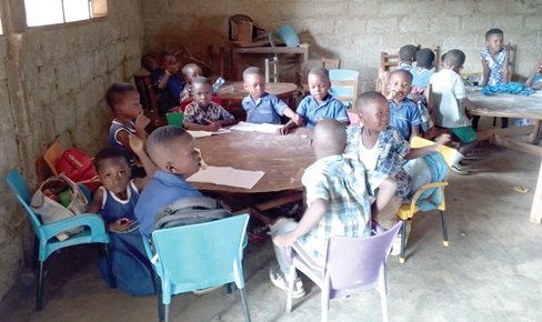 The KG pupils of Chiraa Presbyterian School shifted to one corner of the classroom to escape the direct sunlight from the windows