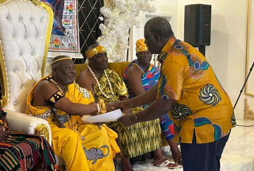 Mr. Henry Obedeka presenting documents to King Odaifio Wellentsi President of the greater Accra regional house of chiefs.