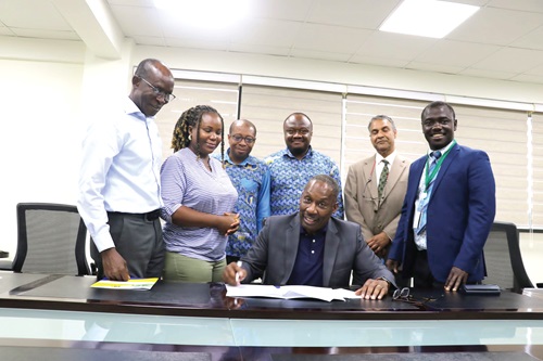 Prof. Thomas LaVeist (seated), leader of the Tulane University team, signing the document while officials of the two universities look on Prof. Thomas LaVeist (seated), leader of the Tulane University team, signing the document while officials of the two universities look on