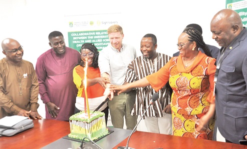 Dr Richard Selby (middle), Sight Savers; Dr Alfred Kwesi Manyeh (2nd from right), Centre for Tropical Diseases, UHAS, and other staff of the university jointly cutting the cake to mark the commencement of the project, while Professor Frank Edwin (left), Pro-Vice-Chancellor of UHAS, looks on Dr Richard Selby (middle), Sight Savers; Dr Alfred Kwesi Manyeh (2nd from right), Centre for Tropical Diseases, UHAS, and other staff of the university jointly cutting the cake to mark the commencement of the project, while Professor Frank Edwin (left), Pro-Vice-Chancellor of UHAS, looks on
