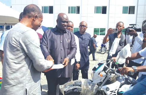 William Dzamefe, the Volta Regional Director of Agric, receiving the key to one of the motorbikes from Eric Opoku, the Minister of Food and Agriculture William Dzamefe, the Volta Regional Director of Agric, receiving the key to one of the motorbikes from Eric Opoku, the Minister of Food and Agriculture