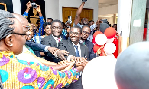  Prof. (Mrs) Rita Akosua Dickson (left), Vice Chancellor, Daniel Aquaye (2nd from left partly covered), CEO, Agrimpact, being assisted by some dignitaries to cut the tape to inaugurate the drone centre. Those with them include Prof. Eric Appau Asante (middle), Director, E-learning Centre, KNUST.