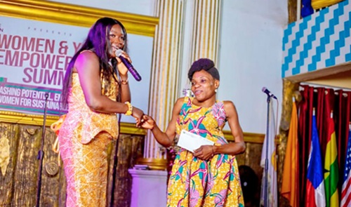 Rev. Love Konadu, President of the Mama Love Foundation, presenting an award to a physically challenged lady for her contribution towards humanity Rev. Love Konadu, President of the Mama Love Foundation, presenting an award to a physically challenged lady for her contribution towards humanity