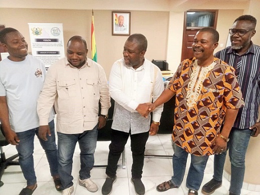 James Gunu (third, right) in a hearty handshake with the Anthony Dagbey, Volta Regional Chairman on MUSIGA during the courtesy call, while members of the union look on Gunu pledges to support MUSIGA in VR to promote culture, tourism