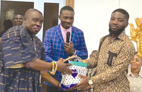 Ignatius Godfred Dordoe (middle), District Chief Executive for Shai-Osudoku, presenting some items to the Osudoku traditional council