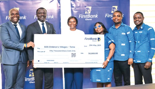 Victor Yaw Asante (2nd from left), MD, FirstBank Ghana, being supported by Enoch Vanderpuye (left), FirstBank Ghana CTL, to present the dummy cheque to Eugenia Cobbina (3rd from left), Fund Development Manager, SOS Children’s Villages Ghana, and Elizabeth Godwyll Ocloo, Programme Director, SOS Tema Location. With them are officials of the two organisations