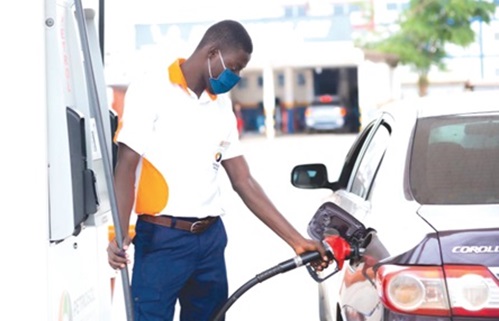 Fuel station attendant serving fuel Fuel station attendant serving fuel