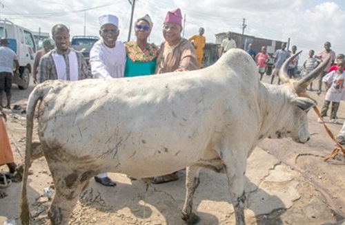Dr Yakubu Diomande (2nd from left) and Gifty E. Appiah (2nd from right), Public Relations Officer, presenting the cow to Alhaji Latif Abdulsalam (right). With them is Salis Nuhu, an employee of Latex Foam