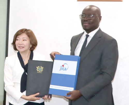 Miyazaki Katsura, Executive Senior Vice President, JICA, with Dr Cassiel Ato Forson, Minister of Finance, exchanging the agreement