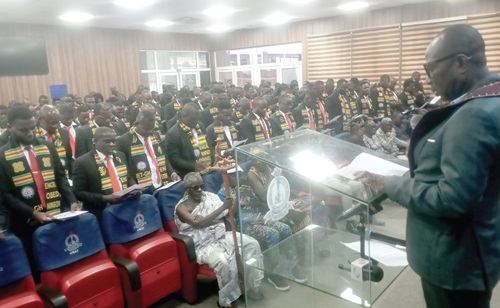 Henry Kwadwo Boateng (right), President, Institution of Engineering and Technology Ghana, inducting the new members