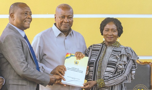 Professor George K.T. Oduro (left), Committee Chairman, National Education Forum, presenting the report to President John Mahama assisted by Prof. Naana Jane Opoku-Agyemang