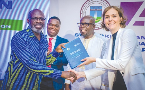 Anna-Lena Sabroso Wasserfall (right), Country Director of KAS, presenting the publication to Prof. Moses Acquah (left), Director of the Ph.D. Programme in Business Administration at the University of North Carolina. Looking on are Prof. Samuel K. Bonsu (2nd from right), Rector, GIMPA, and Prof. Ebenezer Adaku (2nd from left), Deputy Rector, GIMPA Anna-Lena Sabroso Wasserfall (right), Country Director of KAS, presenting the publication to Prof. Moses Acquah (left), Director of the Ph.D. Programme in Business Administration at the University of North Carolina. Looking on are Prof. Samuel K. Bonsu (2nd from right), Rector, GIMPA, and Prof. Ebenezer Adaku (2nd from left), Deputy Rector, GIMPA