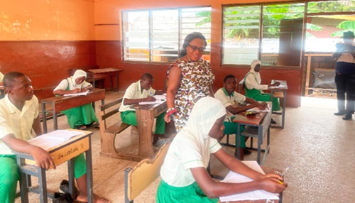 Prof. Smile Dzisi Gavua, a Deputy Director-General in charge of Management Service, GES, observing a candidate writing the BECE at the Nima Cluster of Schools. Picture: ESTHER ADJORKOR ADJEI 