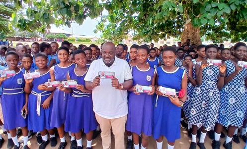 Michael Okyere Baafi (with one of the mathematical sets), MP for New Juaben South, together with the BECE candidates displaying the sets