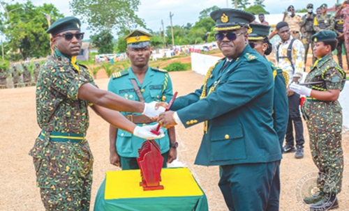 Francis Palmdeti (right), Deputy Commissioner of Immigration, presenting the overall best recruit award to Recruit Officer Mark Selorm Awuku Francis Palmdeti (right), Deputy Commissioner of Immigration, presenting the overall best recruit award to Recruit Officer Mark Selorm Awuku