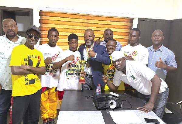 Alhaji Abdulai Pangasur (arrowed) shares a proud moment with Black Rockets medallists, their coaches, and GBF officials after presenting his donation in support of the team Alhaji Abdulai Pangasur (arrowed) shares a proud moment with Black Rockets medallists, their coaches, and GBF officials after presenting his donation in support of the team