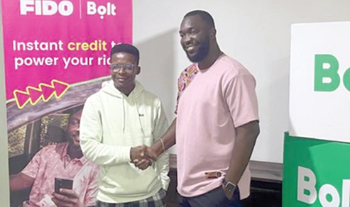 Samuel Ali (left), Operation Lead, Bolt Ghana, in a handshake with Joseph Maxwell Appiah (right), Head of Business Units at Fido Credit, after the launch Samuel Ali (left), Operation Lead, Bolt Ghana, in a handshake with Joseph Maxwell Appiah (right), Head of Business Units at Fido Credit, after the launch