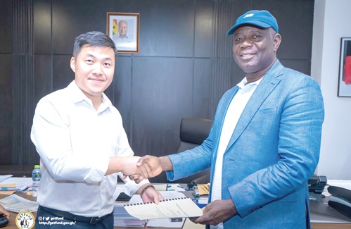 Paul Adjei (right), GETFund Administrator, and Mike Qui Xiaonan, Board member of the Chinese Construction Group, holding the MoU after the signing ceremony Paul Adjei (right), GETFund Administrator, and Mike Qui Xiaonan, Board member of the Chinese Construction Group, holding the MoU after the signing ceremony
