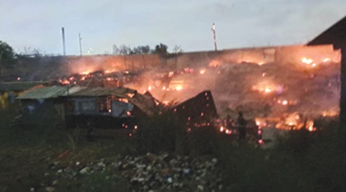 The raging fire causing damage to the wooden structures The raging fire causing damage to the wooden structures