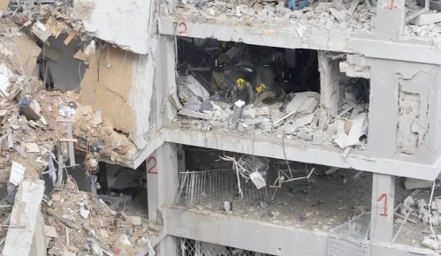 Emergency and rescue workers search for trapped people inside a heavily damaged building Emergency and rescue workers search for trapped people inside a heavily damaged building