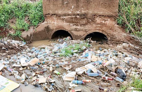 A drain filled with plastic waste