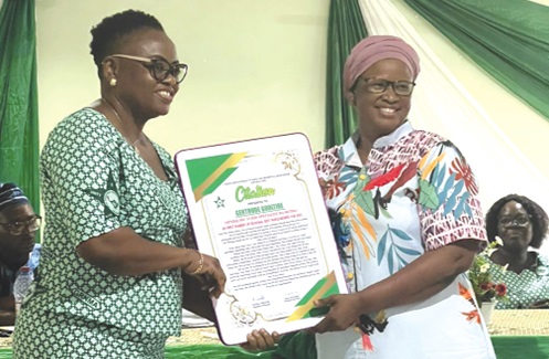 Ms Guoltere (left), receiving a citation Ms Guoltere (left), receiving a citation