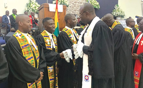 Rt Rev. Dr Abraham Nana Opare Kwakye (right), the Moderator of the General Assembly of PCG, extending a hand of felicitation to an inductee Rt Rev. Dr Abraham Nana Opare Kwakye (right), the Moderator of the General Assembly of PCG, extending a hand of felicitation to an inductee