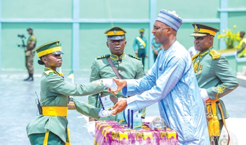 Muntaka Mohammed-Mubarak (2nd from right), Minister for the Interior, presenting an award to one of the best graduating cadets. With him includes Samuel Basintale Amadu (right), Comptroller-General of Immigration 