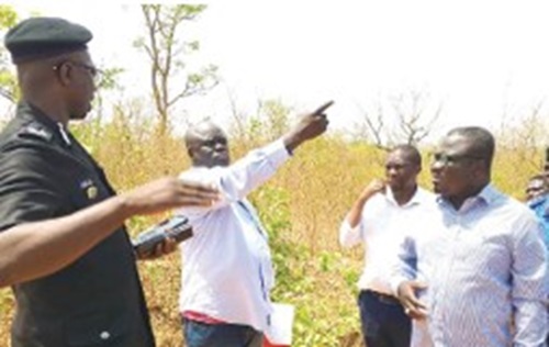  Joseph Addae Akwaboa (right), Bono Regional  Minister, listening to Alex Twumasi, PRO of King Award  Ghana Ltd, who gave directions to the galamsey sites.  With them are DCOP Joseph Gyamera Oklu (left), Bono  Regional Police Commander, and others