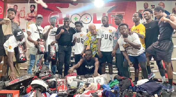 Michael Amoo-Bediako (arrowed) is joined by some excited boxers and officials of the gyms to admire the donated equipment Michael Amoo-Bediako (arrowed) is joined by some excited boxers and officials of the gyms to admire the donated equipment