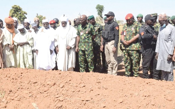  Lieutenant General Taoreed Lagbaja (arrowed), Nigeria’s Chief of Army Staff, with other community leaders praying at the grave of victims of an army drones attack