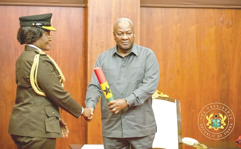 President John Mahama handing the Scroll of Office to Patience Baffoe-Bonnie (left), the Director-General of Prisons President John Mahama handing the Scroll of Office to Patience Baffoe-Bonnie (left), the Director-General of Prisons