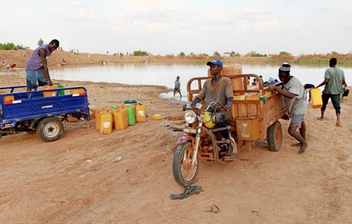 Some tricycle operators fetching water to supply to residents