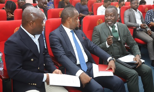  Dominic Ayine (right), Minister for Justice and Attorney-General, interacting with Dr Justice Srem-Sai (2nd from left), the Deputy Attorney-General and Minister for Justice, during the media briefing in Accra. With them is Felix Kwakye Ofosu (left), Government Spokesperson. Picture: SAMUEL TEI ADANO 