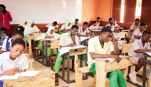 Candidates writing their Basic Education Certificate Examination at the Kanda Cluster of Schools in Accra with invigilators overseeing the session. Picture: CALEB VANDERPUYE