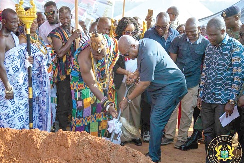 President Mahama (right) being assisted by Nene Offei Ta Gbaja, Divisional Chief of Asesewa, to cut the sod for construction works on the Asesewa market to begin 