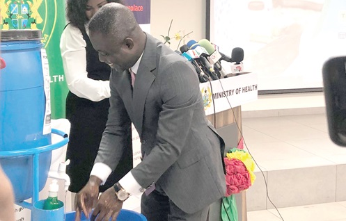 Kwabena Mintah Akandoh (right), Minister of Health, demonstrating proper hand hygiene at the event