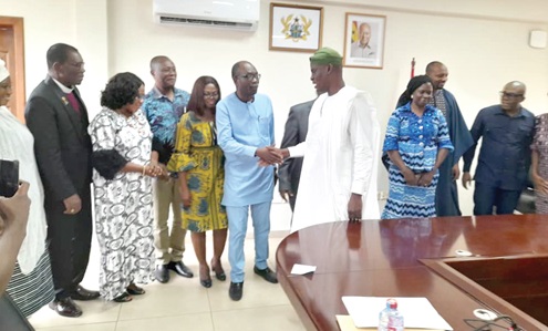 Haruna Iddrisu (4th from right), Minister of Education, congratulating members of the Governing Council of the Ghana Education Service after their induction 