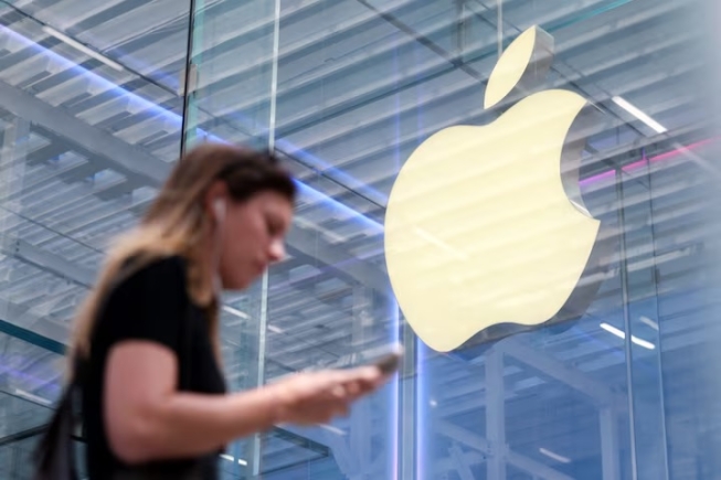 A person walks by the Apple store on Fifth Avenue in New York City, U.S., May 1, 2025. REUTERS/Kylie Cooper/File Photo