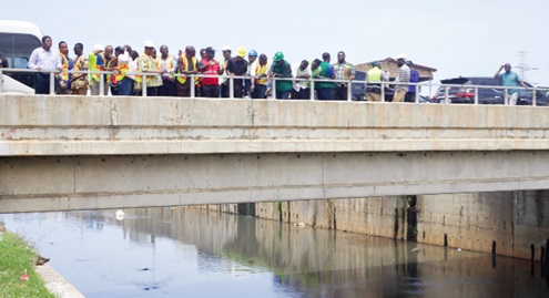 Members of the Parliamentary Select Committee on Works and Housing at the Odaw River project site Members of the Parliamentary Select Committee on Works and Housing at the Odaw River project site