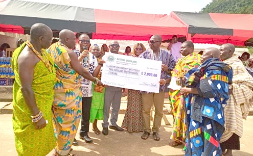 Samuel Aboni (3rd from left), a citizen of Avatime Amedzofe, presenting the dummy cheque of £2,000 to Peter Bosrotsi (4th from right), Chairman of the VACA. Looking on are chiefs, elders and opinion leaders of Avatime Vane Samuel Aboni (3rd from left), a citizen of Avatime Amedzofe, presenting the dummy cheque of £2,000 to Peter Bosrotsi (4th from right), Chairman of the VACA. Looking on are chiefs, elders and opinion leaders of Avatime Vane