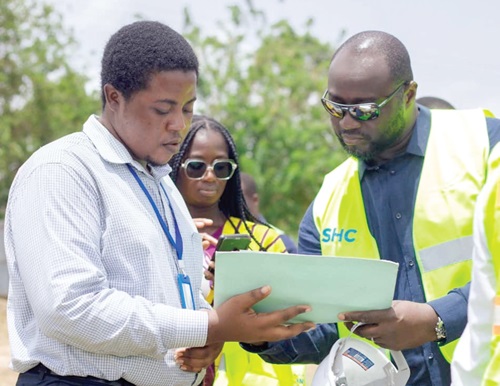 John Bawah (right) being shown some drawings at the Pokuase site John Bawah (right) being shown some drawings at the Pokuase site