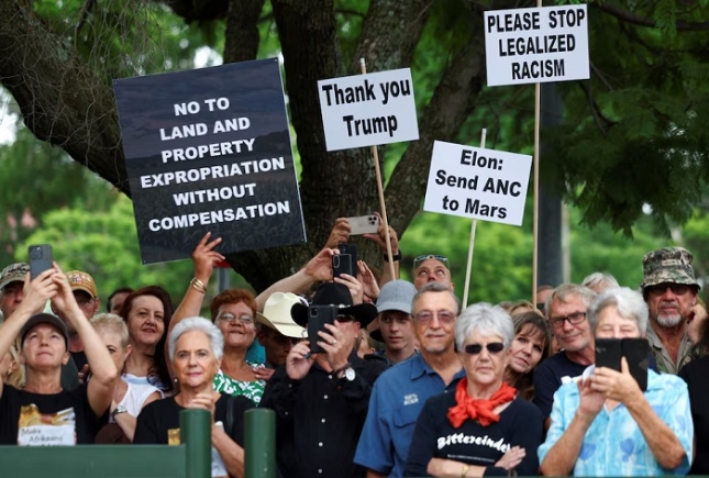 Demonstrators hold placards in support of U.S. President Donald Trump's stance against what he calls racist laws, land expropriation, and farm attacks, outside the American Embassy in Pretoria, South Africa, February 15, 2025. REUTERS Demonstrators hold placards in support of U.S. President Donald Trump's stance against what he calls racist laws, land expropriation, and farm attacks, outside the American Embassy in Pretoria, South Africa, February 15, 2025. REUTERS