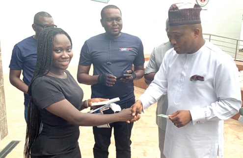 Doreen Klutse (left) in a handshake with Samuel Okudzeto Ablakwa (right), the Minister of Foreign Affairs, after receiving her passport at the Ghana Library Authority head office in Accra, as officials from Ghana Post look on Doreen Klutse (left) in a handshake with Samuel Okudzeto Ablakwa (right), the Minister of Foreign Affairs, after receiving her passport at the Ghana Library Authority head office in Accra, as officials from Ghana Post look on