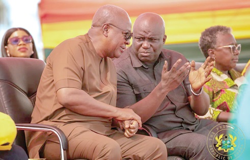 President John Mahama conferring with Eric Opoku, Minister of Agriculture, during the launch of the Feed Ghana Programme 
