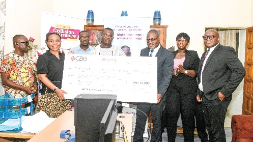 Harry Ofori-Attah (3rd from right), Managing Director of Imperial General Assurance, presenting the dummy cheque  to the KBTH management