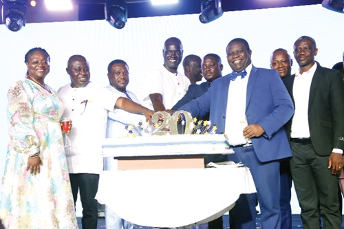 Alex Bram (middle), CEO, Hubtel, being assisted by Samuel Nartey George (3rd from left), Minister of Communication, Digital Technology and Innovations, Patience Enyonam Akyianu (left), CEO, Hollard Insurance, and some dignitaries to cut the cake to mark the 20th anniversary. Picture: ELVIS NII NOI DOWUONA Alex Bram (middle), CEO, Hubtel, being assisted by Samuel Nartey George (3rd from left), Minister of Communication, Digital Technology and Innovations, Patience Enyonam Akyianu (left), CEO, Hollard Insurance, and some dignitaries to cut the cake to mark the 20th anniversary. Picture: ELVIS NII NOI DOWUONA