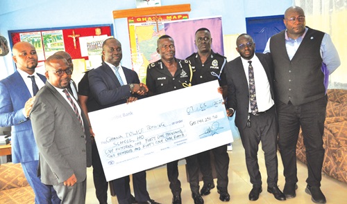 Harry Opoku-Agyemang (3rd from left), the Head of Personal Banking, Stanbic Bank, presenting the cheque to ACP William Yankey Acolatse, while other officials of the bank look on