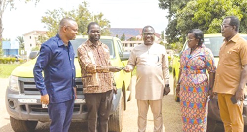 Kwadwo Otopah-Poakwa (2nd from left), Manager of the BPA, handing over keys to the vehicles to Joseph Addae Akwaboa, Bono Regional Minister Kwadwo Otopah-Poakwa (2nd from left), Manager of the BPA, handing over keys to the vehicles to Joseph Addae Akwaboa, Bono Regional Minister